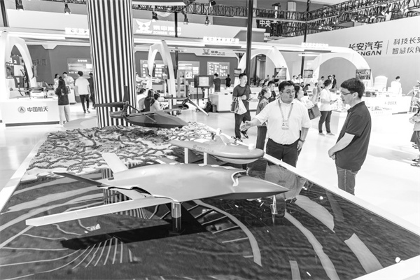 3-2 2，工作人员在西洽会上向观众.jpg