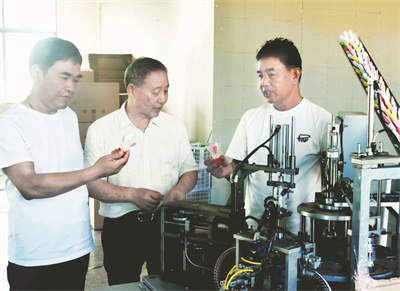 1723301039724197.jpg 4-1 1 1 图中为黄惟善在查看嗒嗒球自动生产线.jpg