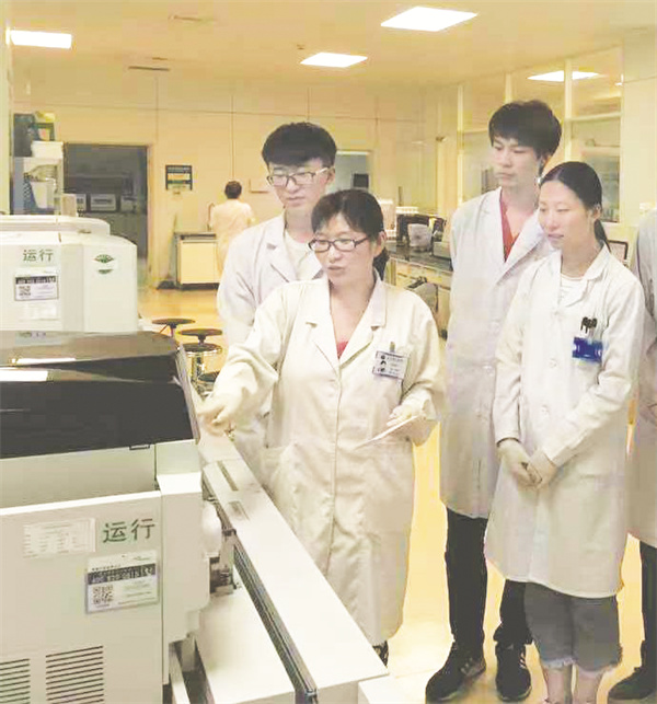 5-4 6 赵梦麒在指导学生使用检验仪器.jpg